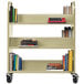 A Hirsh Industries putty book cart with books on shelves.