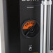 A Bunn black coffee server with black and orange buttons.
