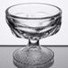 A clear Libbey sherbet glass with a small pedestal on a table.