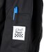 A close-up of a black Chef Revival chef coat pocket with a blue pen in it.