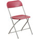 A Flash Furniture red plastic folding chair with a metal frame.