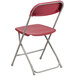 A red Flash Furniture plastic folding chair with a metal frame.