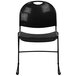 A black Flash Furniture stack chair with a metal frame.