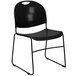 A Flash Furniture black plastic stack chair with metal legs.