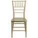 A gold Flash Furniture Hercules chiavari chair with a wooden seat on a white background.
