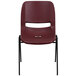 A burgundy plastic Flash Furniture Hercules Series stack chair with black legs.