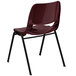 A burgundy plastic Flash Furniture student chair with black legs.