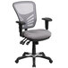 A grey office chair with black arms and wheels.