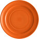 An orange Tuxton Concentrix china plate with a spiral pattern.