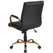 A Flash Furniture black leather swivel office chair with gold metal legs.