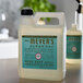 A Mrs. Meyer's Clean Day Basil scented liquid hand soap refill bottle on a counter.