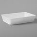 An American Metalcraft Del Mar white rectangular container on a gray surface.