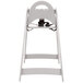 A grey Koala Kare high chair with a black seat and a strap on top.