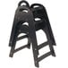 A stack of unassembled black Koala Kare high chairs.