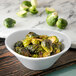 A Carlisle Griege Melamine bowl filled with brussels sprouts.