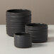 Three American Metalcraft round gray porcelain sauce cups with ribbed sides.