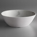 A white Carlisle melamine bowl with a gray marble surface.