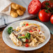 A Carlisle marble melamine salad plate with pasta, chicken, and vegetables.