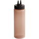 A Vollrath brown plastic squeeze bottle with a black Twin Tip lid with two pointy spikes.