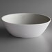 A white Carlisle melamine bouillon bowl with a gray marble surface.
