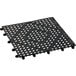 A 12 pack of black plastic interlocking bar mats with holes.