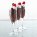 A Libbey Embassy flute glass filled with chocolate pudding topped with raspberries.