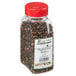 A plastic container of Regal Gourmet Peppercorn Medley with black and red peppercorns.
