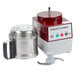 A Robot Coupe R2N food processor with a stainless steel bowl and continuous feed lid with a blender blade inside.