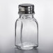 A close-up of an Anchor Hocking glass salt shaker with a metal top.