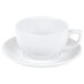 A close-up of a CAC white porcelain cappuccino cup on a saucer.