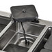 A Vollrath drop-in hot food well with black covers on a black surface.