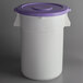 A white plastic round ingredient storage bin with a purple lid.