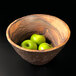 An Elite Global Solutions Sequoia melamine serving bowl filled with green apples.