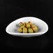 A gray speckled melamine triangle bowl filled with green olives.