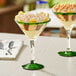 Two Acopa martini glasses filled with banana pudding and whipped cream on a table.