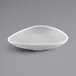 A gray speckled melamine triangle bowl with a white background.