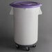 A white container with wheels and a purple lid.