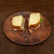 An Elite Global Solutions checkered melamine plate with a sandwich cut in half topped with meat and lettuce.
