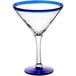A clear Acopa martini glass with a blue rim.