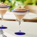 A chocolate dessert in an Acopa martini glass with a blue rim and base.