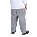 A person wearing Chef Revival houndstooth chef trousers and a white shirt.