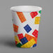 A white paper cup with colorful lego blocks on it.