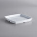 A white square GET Milano bowl insert on a gray surface.