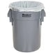 A grey plastic trash can with a BioStar compostable trash can liner inside.