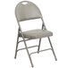 A Flash Furniture gray metal folding chair with a padded seat.