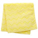 A folded yellow Rubbermaid microfiber cloth on a white background.