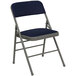 A navy blue Flash Furniture metal folding chair with a padded seat.