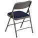 A navy blue metal folding chair with a padded seat.
