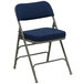 A navy blue metal folding chair with a padded fabric seat.