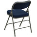 A navy blue metal folding chair with a cushioned seat.